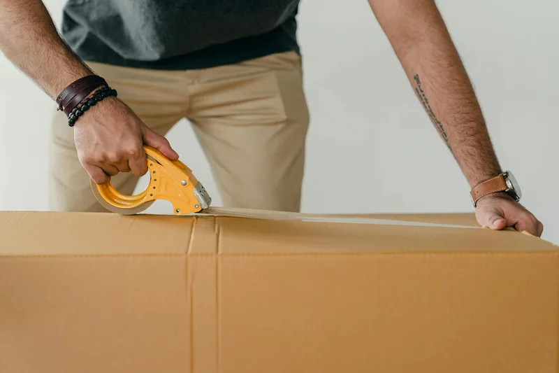 Step-by-step return packing process showing bubble wrap wrap, carton box, return airway bill placement, and H-tape seal method for Shopee Malaysia returns