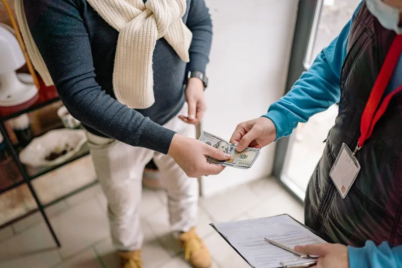 Cash changing hands during a cash-on-delivery payment exchange