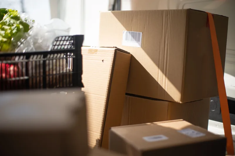 Sealed, labeled cardboard boxes stacked in a delivery vehicle ready for shipment